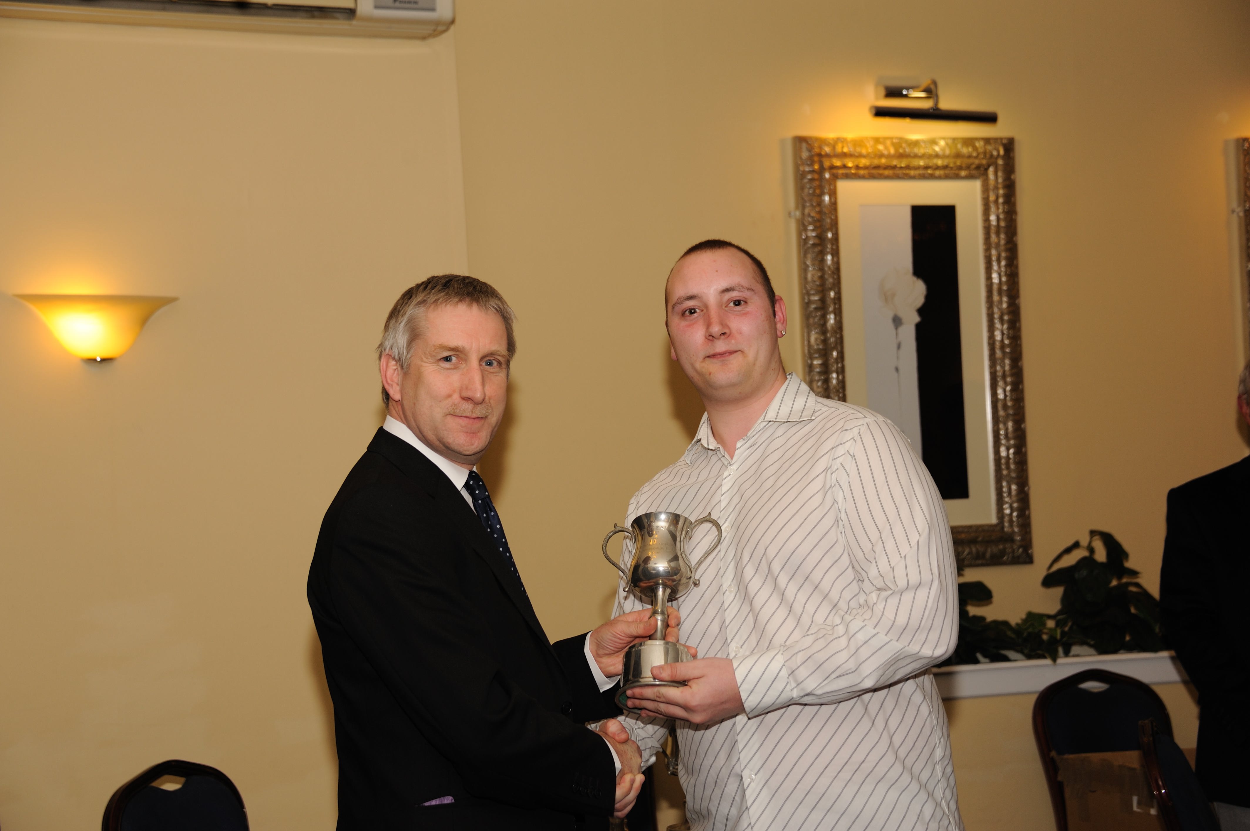 Phil Scotcher, General Manager of TDK-Lambda UK, presents Ryan Podmore with the Group Training and Development (GTD) Award